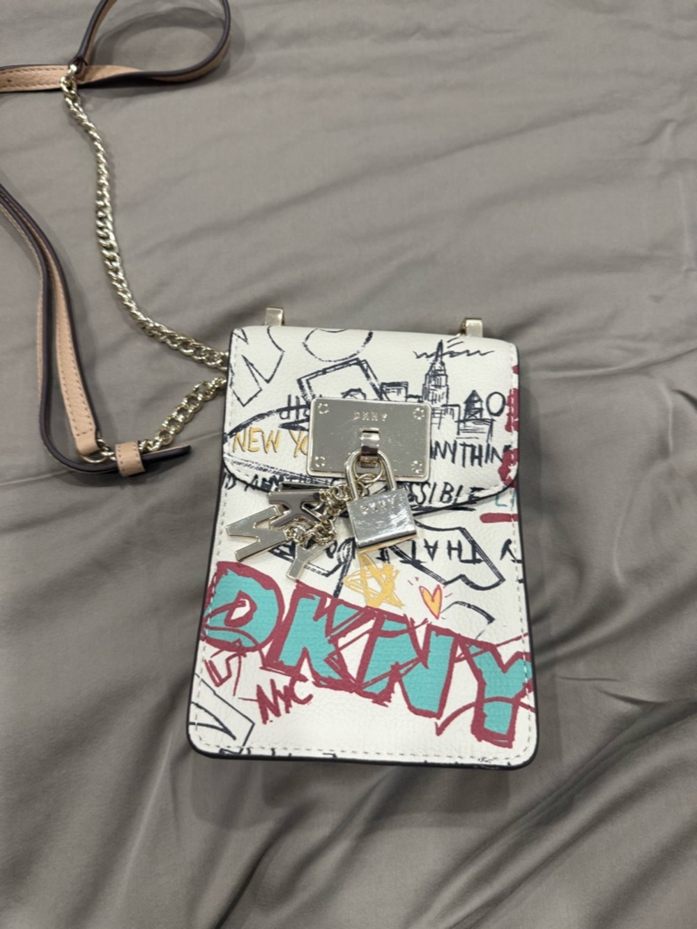 DKNYC White Graffiti Crossbody Bag with Teal and Red Accents